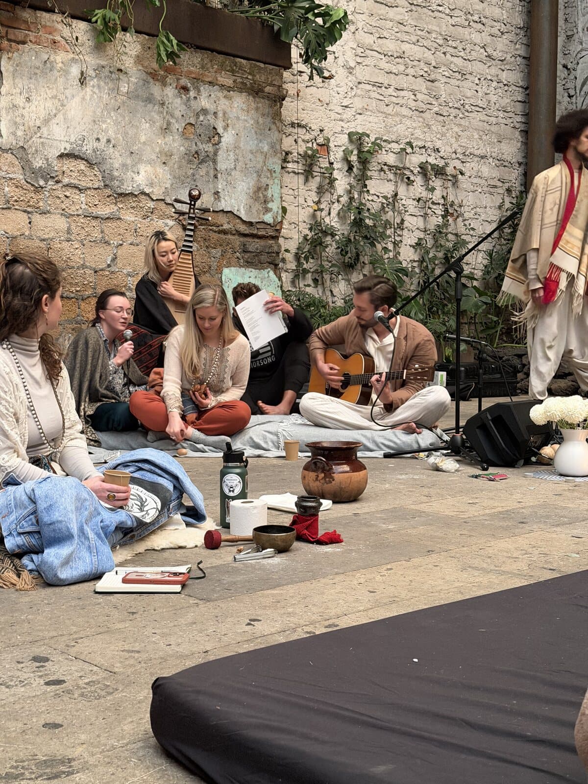 Friends playing music together during an afternoon session in the courtyard