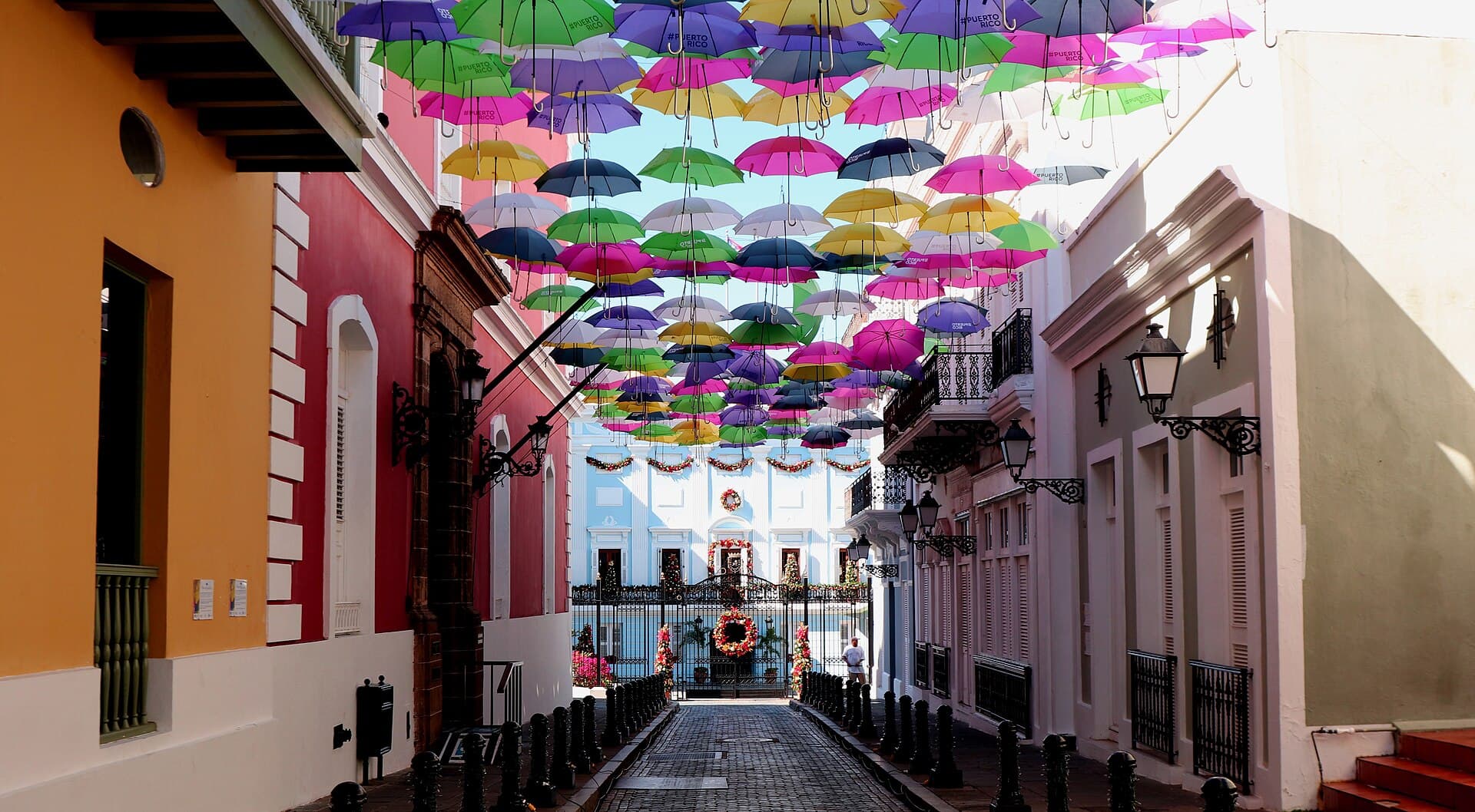 A canopy of colored umbrellas strung above Calle Fortaleza in Old San Juan